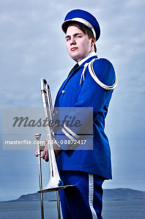Portrait of young man holding trombone