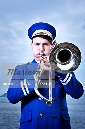 Portrait of young man playing trombone