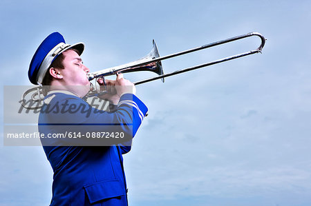 Portrait of young man playing trombone