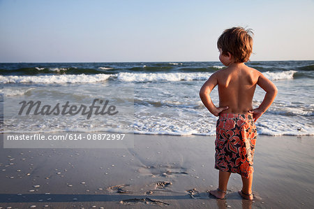 Young boy looking out to sea