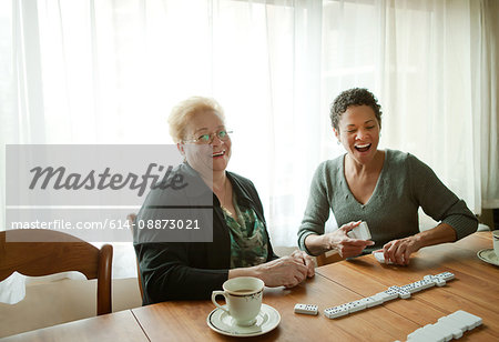 Mother and adult daughter playing dominoes