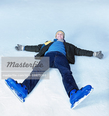 Man lying flat on his back on ice