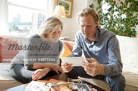 Mother and adult son looking at photographs