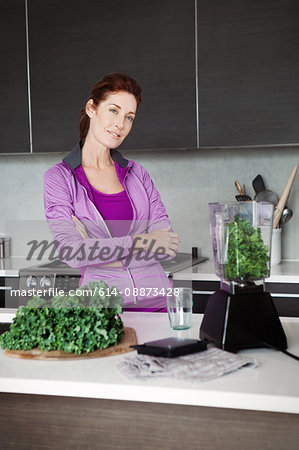 Mature woman making vegetable juice