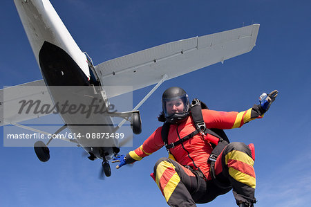 Woman freefly skydiving from airplane