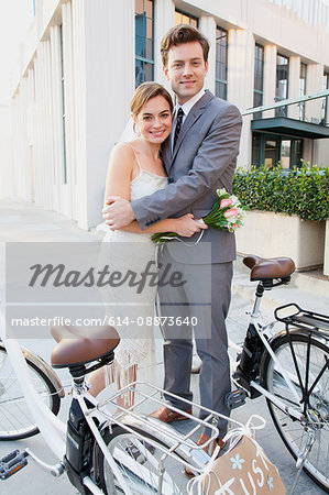 Portrait of young newlywed couple with bicycles