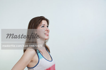 Young adult woman smiling and looking up