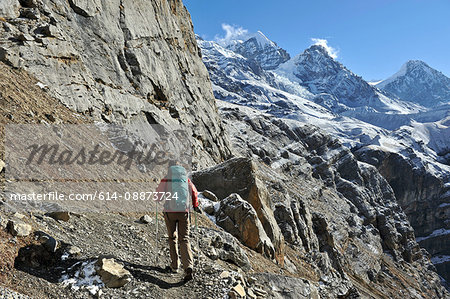 Female trekker following trail, Thorung La, Nepal
