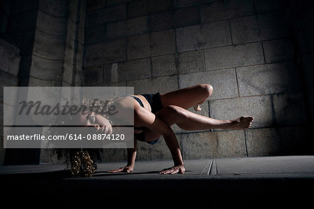 Woman balancing on hands on floor