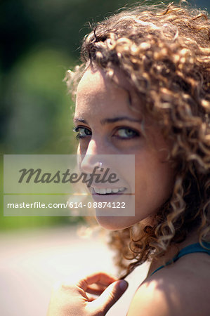 Woman with curly hair and nose ring, close up