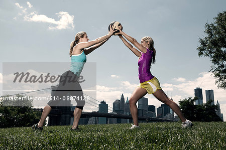 Two women holding ball