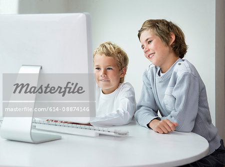 Brothers looking at computer screen