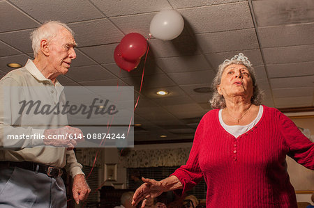Senior man and woman dancing at party