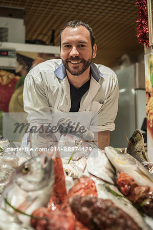 Male fishmonger in market