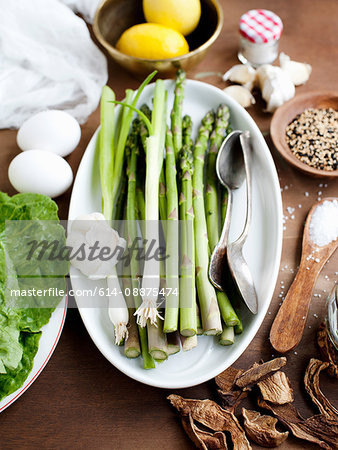 Studio shot of asparagus, surrounded by other ingredients