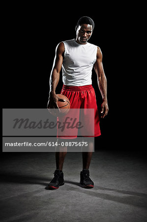 Studio shot of basketball player holding ball