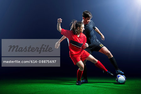 Male and female soccer players in action