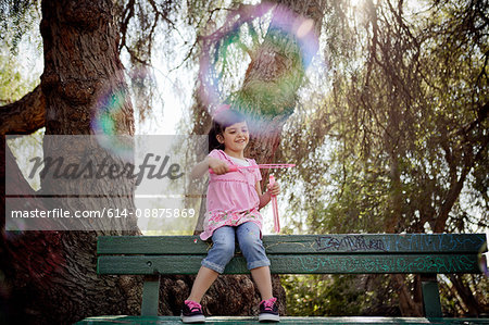 Girl playing with soap bubbles