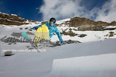 Male skier mid air with crossed skis