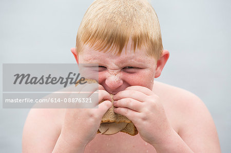 Portrait of boy eating sandwich