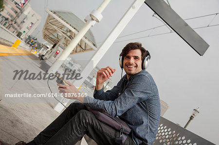 Man wearing headphones at station, Los Angeles, California, USA