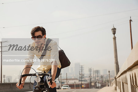 Man cycling on road, Los Angeles, California, USA