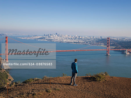 Young male tourist looking at Golden gate bridge, San Francisco, California, USA