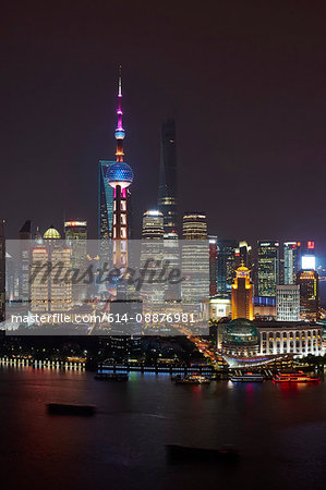 Oriental Pearl Tower at night,  Shanghai Tower (under construction) and Shanghai World Financial Centre in Pudong, Shanghai, China