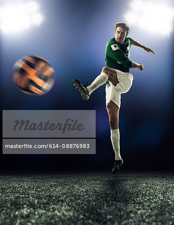 Footballer kicking ball