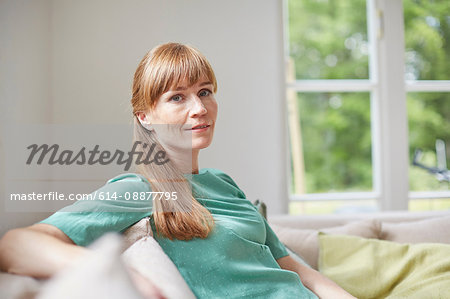 Portrait of red haired mid adult woman looking at camera