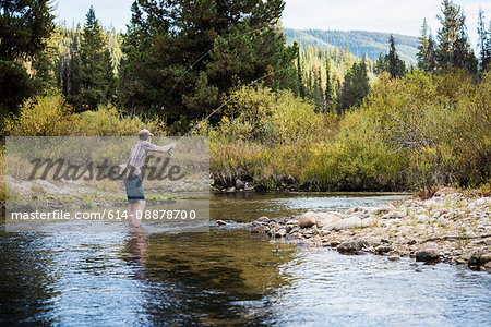 Man in river fly fishing, near Lolo Pass Bitterroot Mountains, Missoula, Montana, USA