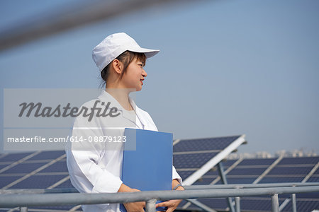 Female worker on roof of solar panel assembly factory, Solar Valley, Dezhou, China