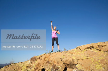 Female runner celebrating on top of hill, Thousand Oaks, California, USA