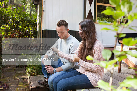 Couple pouring coffee on chalet porch