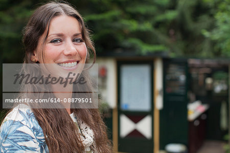 Portrait of young woman in front of chalet