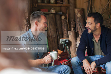 Over the shoulder view of two men talking in cabin