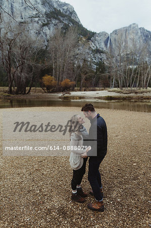 Romantic hiking couple by lake, Yosemite National Park, California, USA