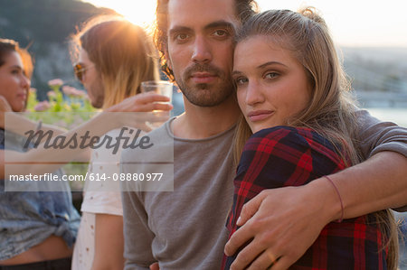 Portrait of couple at waterfront roof terrace party, Budapest, Hungary