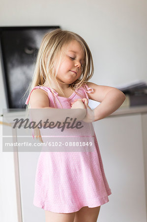 Girl standing with hands clasped