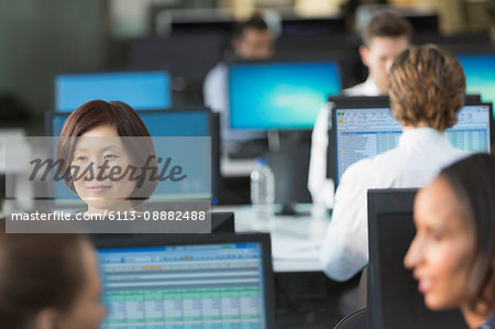 Businesswoman working at computer in open plan office