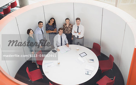 Portrait smiling business people meeting at round table conference room