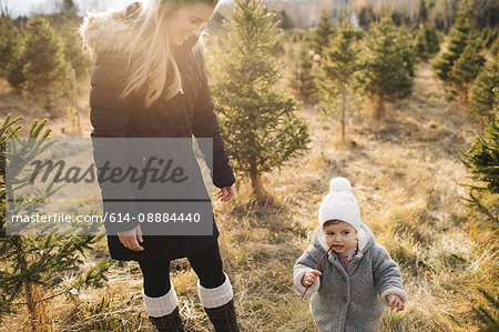 Mother and baby girl in Christmas tree farm, Cobourg, Ontario, Canada