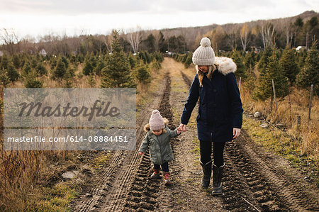 Mother and baby girl in Christmas tree farm, Cobourg, Ontario, Canada