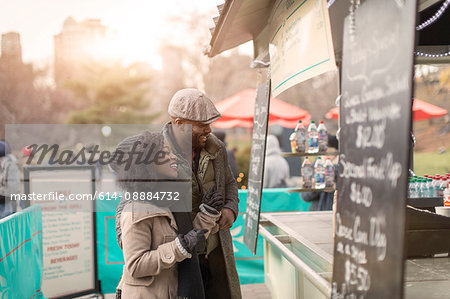 Couple choosing food at food stall, New York, USA