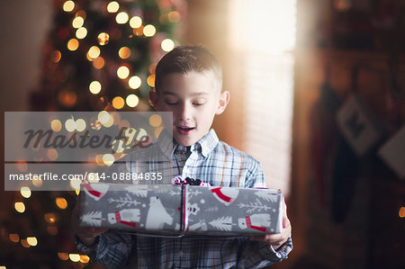 Young boy holding christmas gift