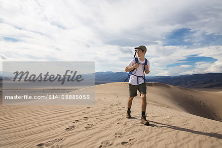 Trekker running in Death Valley National Park, California, US