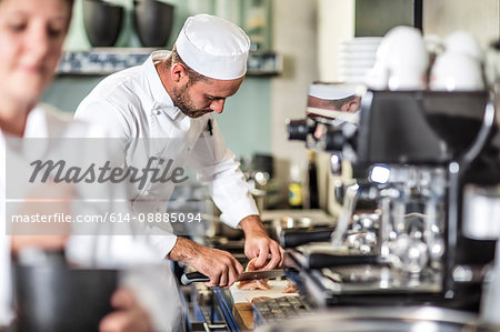 Chef preparing food in kitchen Chef preparing food in kitchen