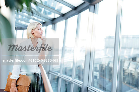 Businesswoman looking through window