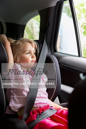 Girl in car looking through window