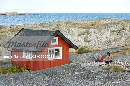 Mother with son relaxing at coast